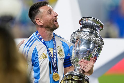 Argentina's Lionel Messi celebrates with the trophy